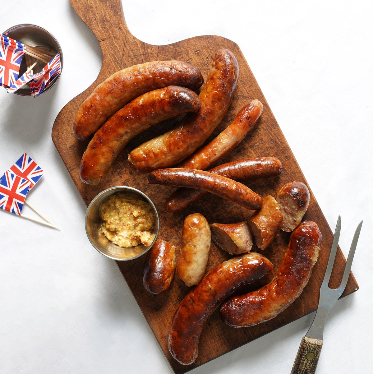 Butcher's box of assorted bangers on a cutting board